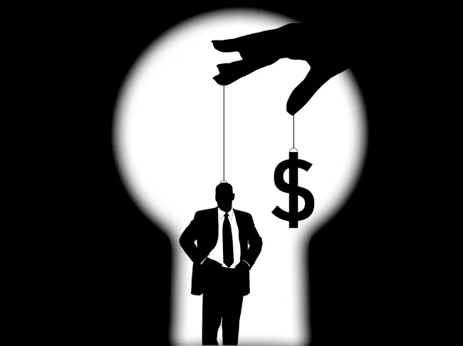 Puppet master holding man an money on string